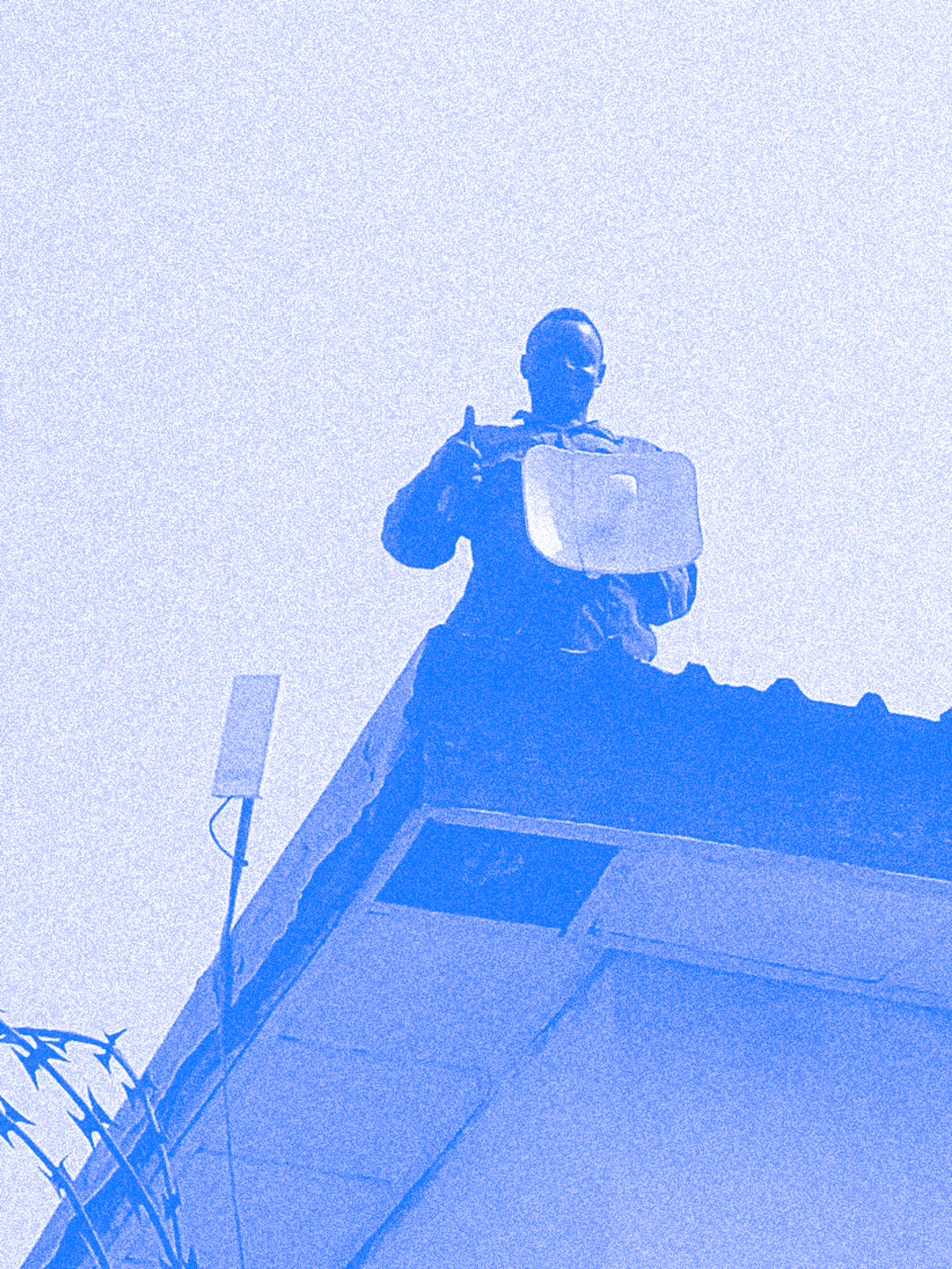 A person holding an Althea network antenna on a roof in Abuja, Nigeria.