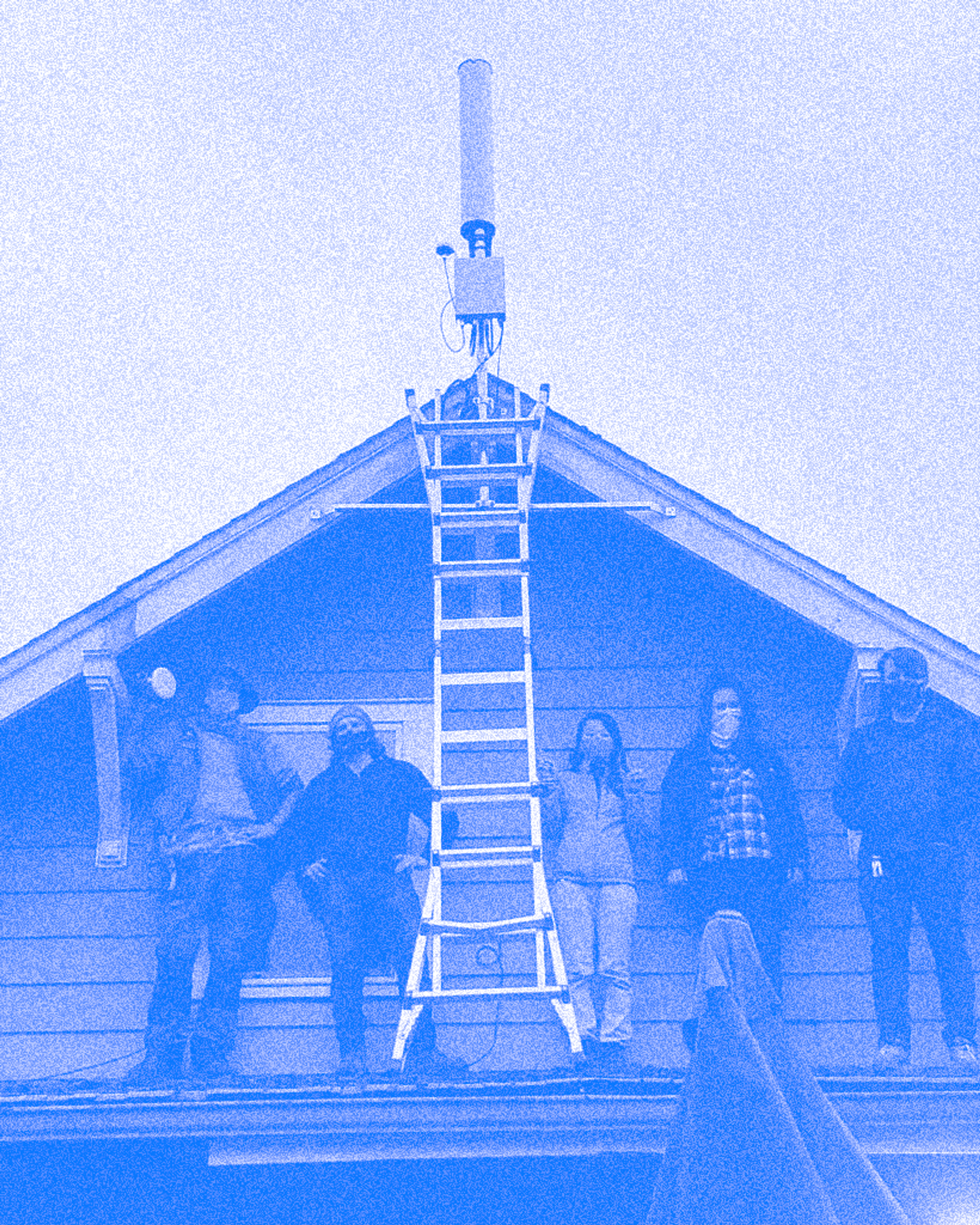 A photo of UW Cooperative Network members on the roof of a home, installing an antenna.